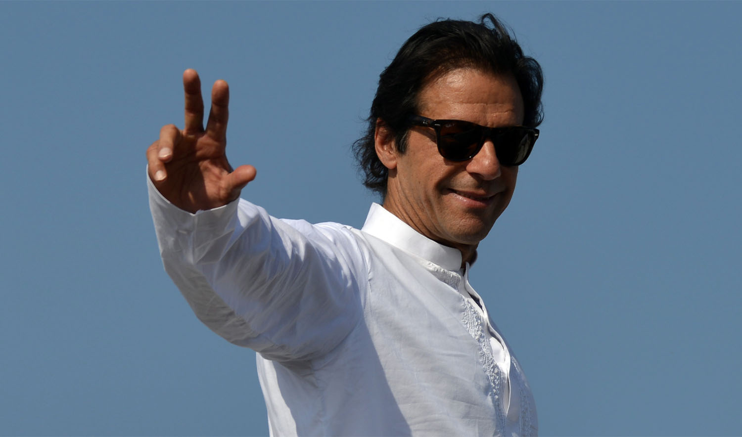 In this file photo, Pakistan Tehreek-e-Insaf (PTI) chief Imran Khan gestures to supporters at the site of an anti-government protest in front of the Parliament in Islamabad on Aug. 29, 2014. (AAMIR QURESHI/AFP)