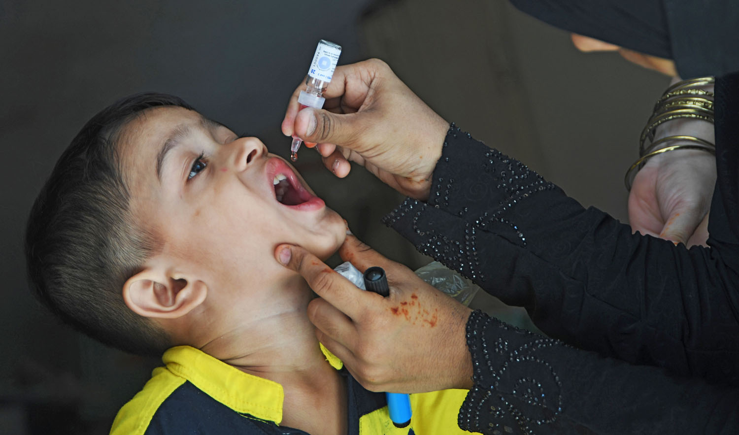 In this file photo, a Pakistani child receives polio vaccine drops during a polio vaccination campaign in Karachi on May 7, 2018. (ASIF HASSAN/AFP)