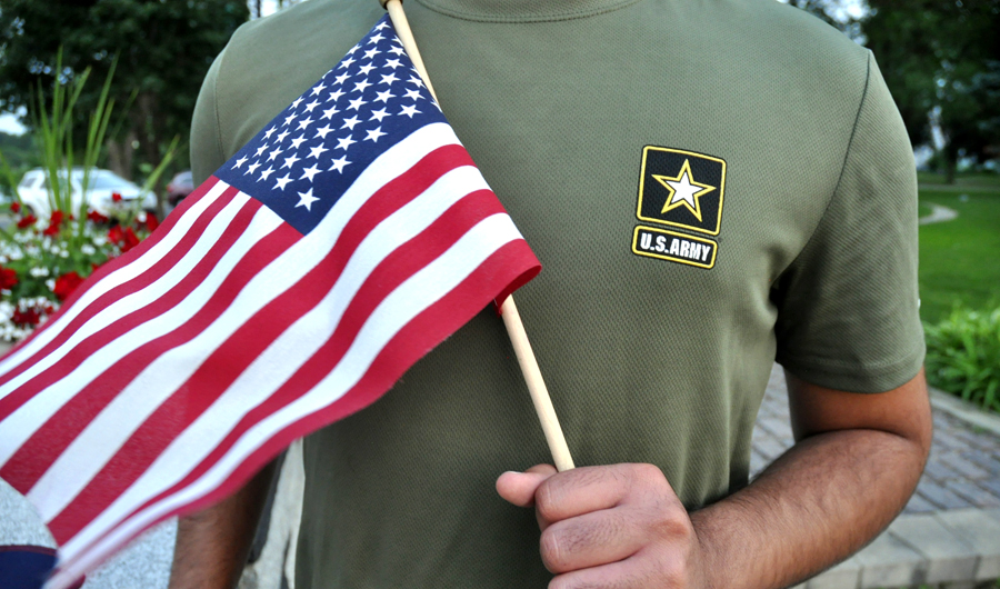 In this July 3, 2018, file photo, a Pakistani recruit, 22, who was recently discharged from the US Army, holds an American flag as he poses for a picture. The U.S. Army has stopped discharging immigrant recruits who enlisted seeking a path to citizenship - at least temporarily. (AP)