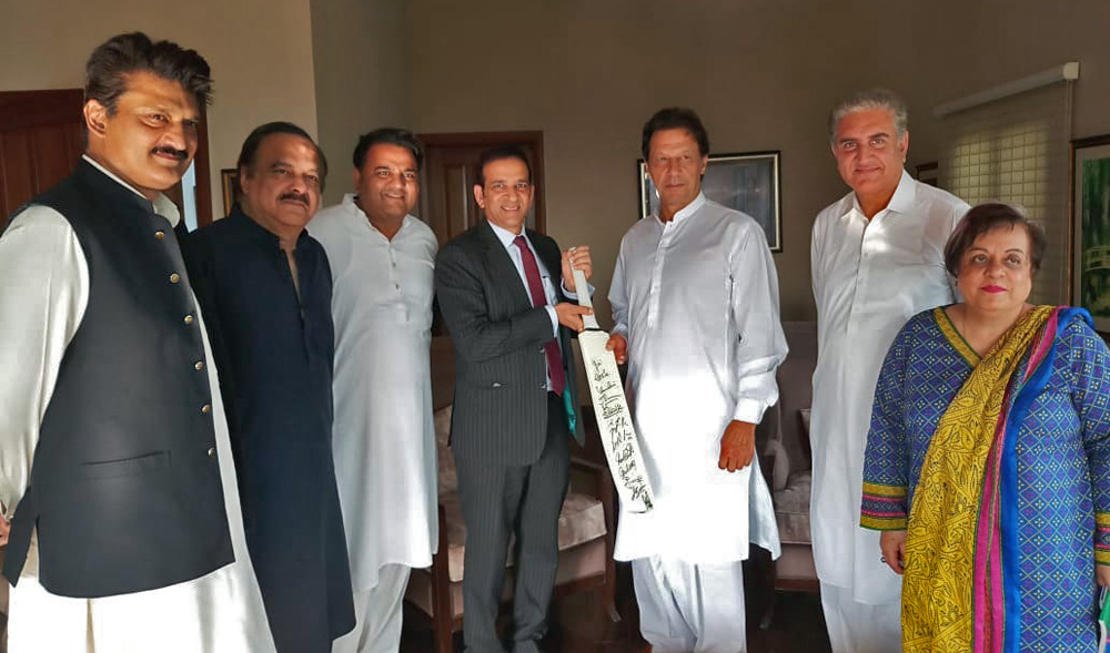 Indian High Commissioner Ajay Bisaria presents a cricket bat to Imran Khan in Islamabad on Friday. (Photo courtesy: PTI media cell)