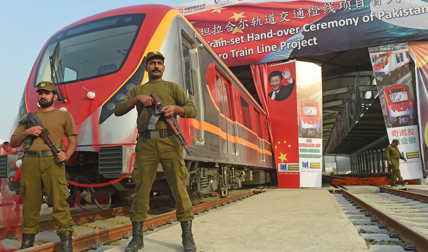 In this file photo, Pakistani policemen stand guard during the unveiling ceremony of the first set of carriages of Lahore Orange Line MetroTrain in Lahore on October 8, 2017. (ARIF ALI/AFP)