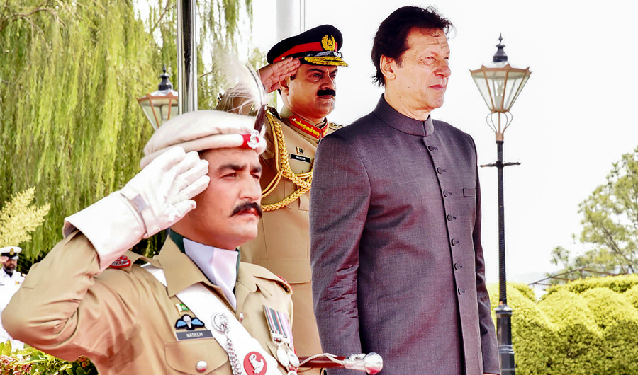 In this handout photograph released by the Press Information Department (PID) on August 18, 2018, newly appointed Pakistani Prime Minister Imran Khan inspects guard of honor on his arrival in the Prime Minister House during a ceremony in Islamabad. (AFP)