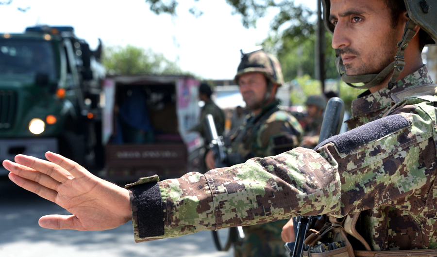 In this file photo taken on August 1, 2018 Afghan National Army (ANA) soldiers search vehicles at a checkpoint in Jalalabad. Afghan President Ashraf Ghani declared a provisional three-month ceasefire with the Taliban in a televised broadcast on August 19, but said the truce would hold only if the insurgents reciprocated. (AFP)