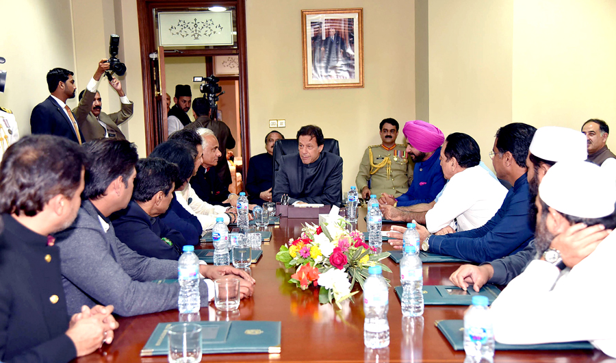 In this photograph released by the Press Information Department (PID) on Aug. 18, 2018, newly appointed Pakistani Prime Minister Imran Khan (C) meets with members of the 1992 Cricket world cup team and former Indian cricketer Navjot Singh Sidhu (top R) in Islamabad. (AFP)