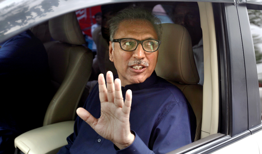 Arif Alvi, a lawmaker from ruling Imran Khan' s Tehreek-e-Insaf party waves to media after filing his nomination papers for presidential election, in Islamabad, Pakistan, on Aug. 27, 2018. (AP)