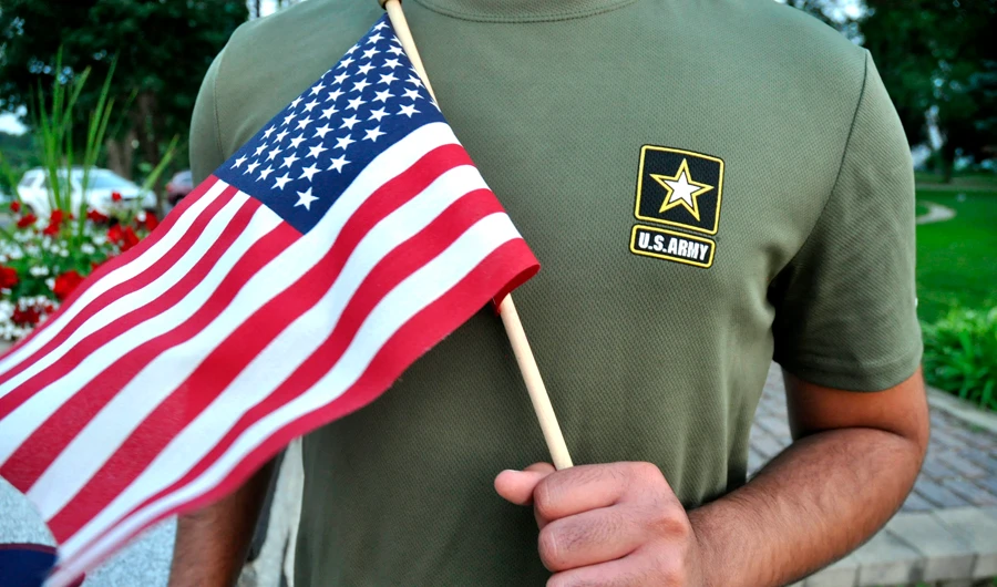 In this July 3, 2018, file photo, a Pakistani recruit, 22, who was recently discharged from the US Army, holds an American flag as he poses for a picture. The U.S. Army has stopped discharging immigrant recruits who enlisted seeking a path to citizenship - at least temporarily. (AP)