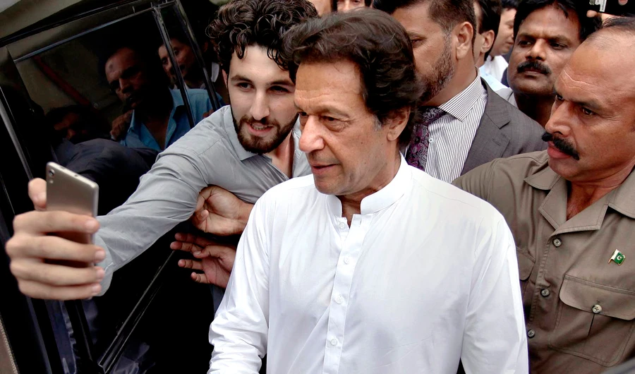 A Pakistani takes selfie with Imran Khan, center, head of the Pakistan Tehreek-e-Insaf party, as he leaves a party meeting in Islamabad, Pakistan, on Aug. 6, 2018. (AP)