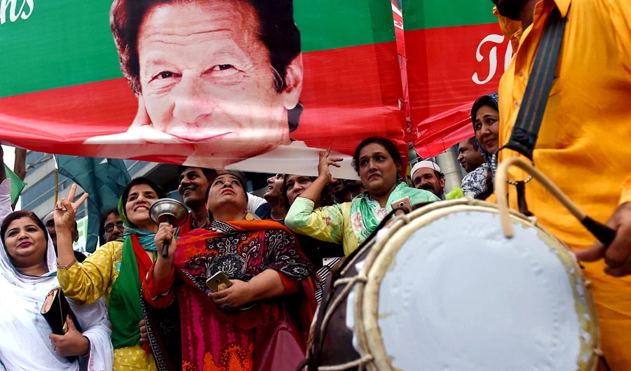 Supporters of Pakistan's cricketer-turned politician and head of the Pakistan Tehreek-e-Insaf (Movement for Justice) Imran Khan, celebrate after Khan takes oath as a Prime Minister, in Lahore on August 18, 2018. (AFP)
