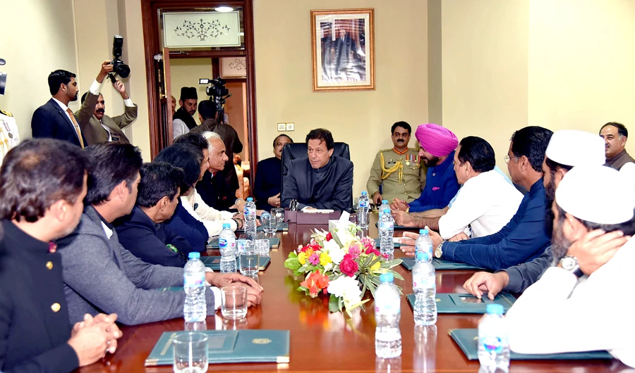 In this photograph released by the Press Information Department (PID) on Aug. 18, 2018, newly appointed Pakistani Prime Minister Imran Khan (C) meets with members of the 1992 Cricket world cup team and former Indian cricketer Navjot Singh Sidhu (top R) in Islamabad. (AFP)