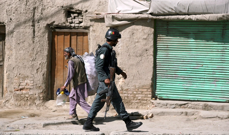 An Afghan security officer arrives at an area near a house where attackers are hiding, in Kabul, Afghanistan, Tuesday, Aug. 21, 2018. (AP)