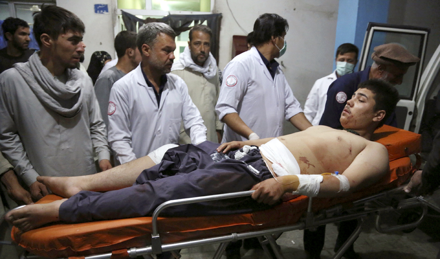 An injured man is brought in to a hospital following a deadly attack in Kabul, Afghanistan, on Wednesday, Sept. 5, 2018. Twin bombings at a wrestling training center in a Shiite neighborhood of Afghanistan's capital on Wednesday killed at least 20 people and wounded others, Afghan officials said. (AP Photo/Rahmat Gul)