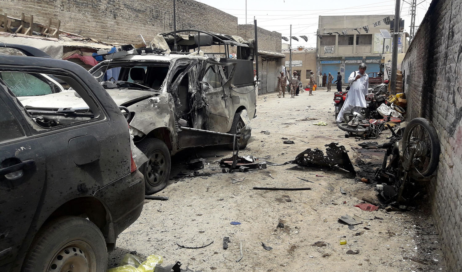In this file photo, Pakistani security officials gather at the site of a bomb explosion targeting the police chief in the border town of Chaman on July 10, 2017. (ASGHAR ACHAKZAI/AFP/FILE)