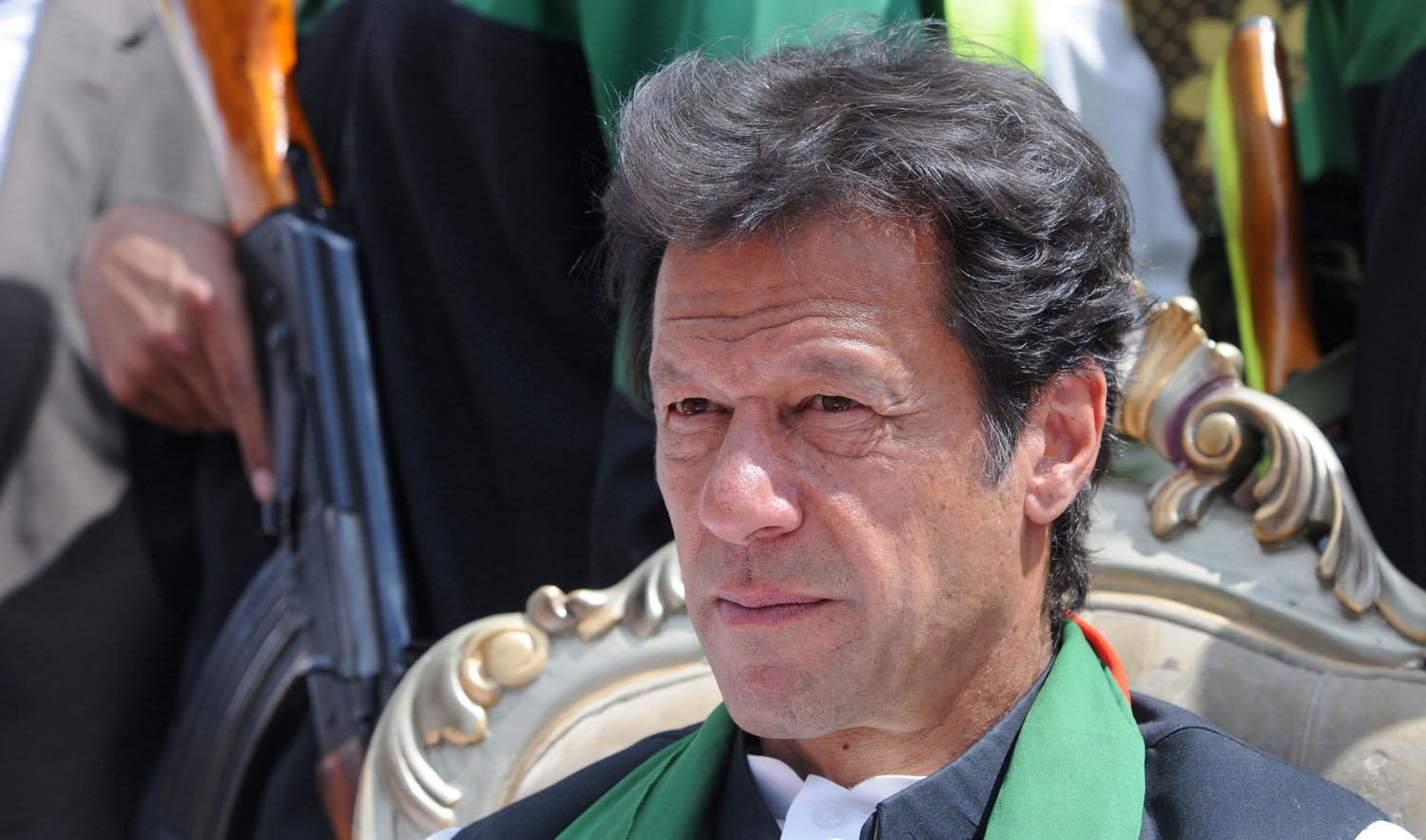 In this file photo, chairman of Pakistan Tehreek-e-Insaaf (PTI) or Movement for Justice party, Imran Khan is escorted by police commandos as he attends a general election campaign meeting in Murree on April 29, 2013. (AAMIR QURESHI/AFP)