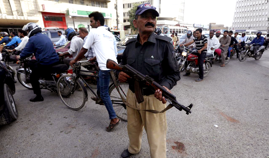 In this file photo, A policeman stands guard near a checkpoint along a road in Karachi, Pakistan. (REUTERS)