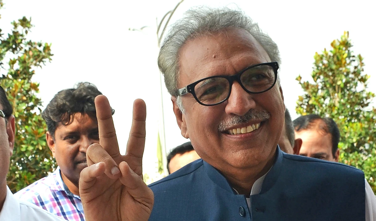 Newly elected president of Pakistan Arif Alvi flashes the victory sign on his arrival before the presidential election at the National Assembly in Islamabad on Sept. 4, 2018. (FAROOQ NAEEM/AFP)