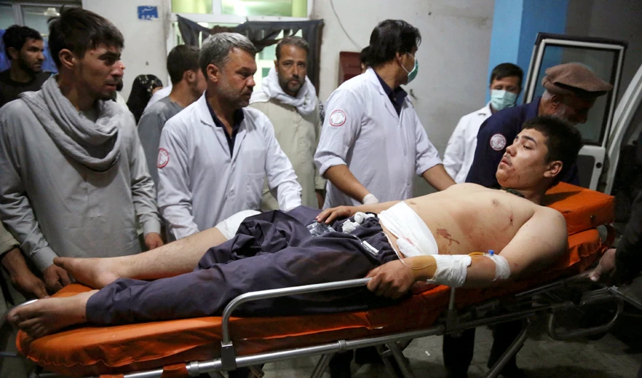 An injured man is brought in to a hospital following a deadly attack in Kabul, Afghanistan, on Wednesday, Sept. 5, 2018. Twin bombings at a wrestling training center in a Shiite neighborhood of Afghanistan's capital on Wednesday killed at least 20 people and wounded others, Afghan officials said. (AP Photo/Rahmat Gul)
