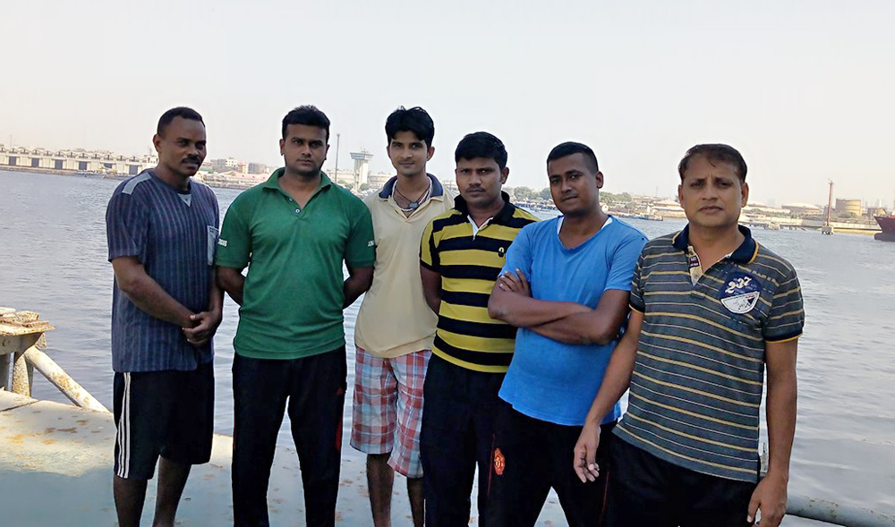 Indian nationals Amit Kumar, Rama Shankar Prasad, Niraj Kumar, Rajendra Kumar and Rajesh Shikh with Sudanese citizen Khalid Noor aboard Cargo Ship at Karachi Port. (Photo supplied by the ship crew)