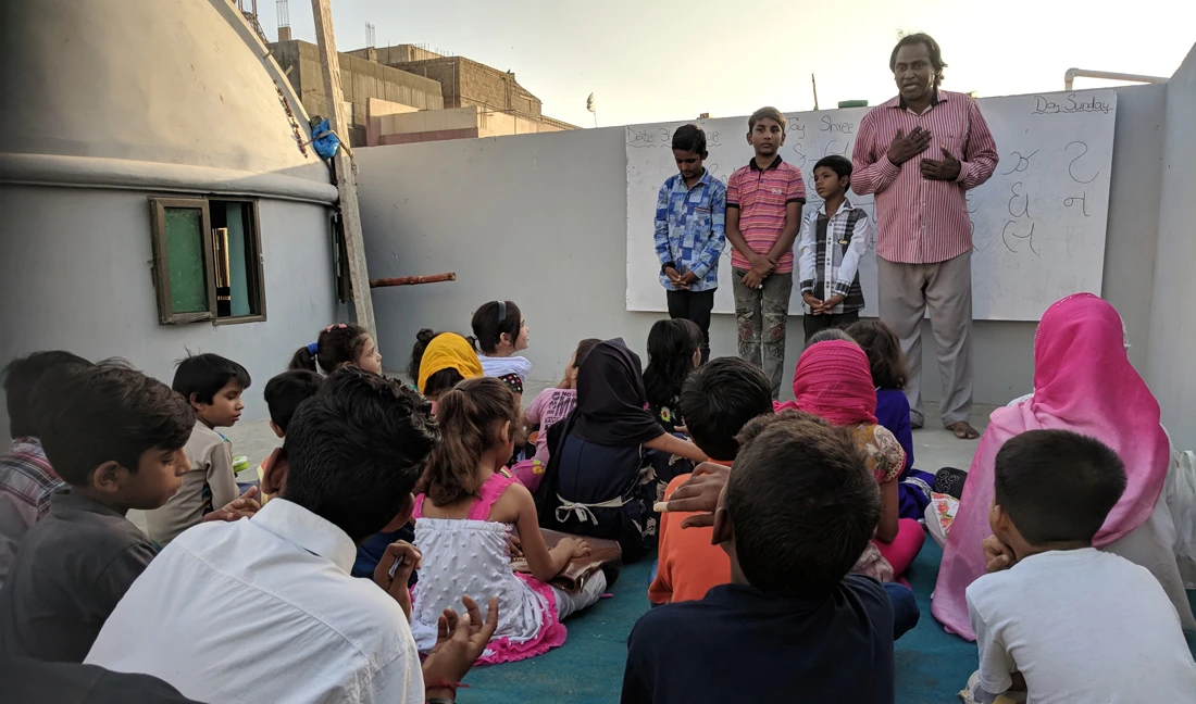 A man teaches Gujarati language to his students at the rooftop of three-story Shri Ramdev Pir temple in Soldier Bazaar area of Karachi, a Pakistani megacity housing around 3.5 million people of Gujarati descent. ( AN photo by M.F. Sabir)