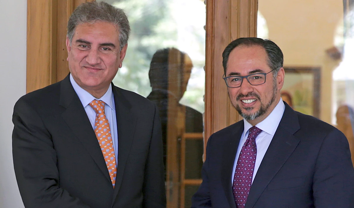 In this file photo, Pakistan’s Foreign Minister, Shah Mahmood Qureshi, left, shakes hands with his Afghan counterpart Salahuddin Rabbani in Kabul, Afghanistan, Saturday, Sept. 15, 2018. (AP)