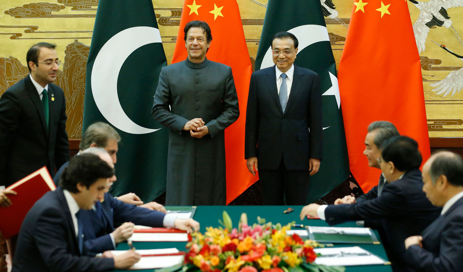 Pakistani Prime Minister Imran Khan, left, and China’s Premier Li Keqiang attend a signing ceremony at the Great Hall of the People in Beijing on November 3, 2018. (AFP)
