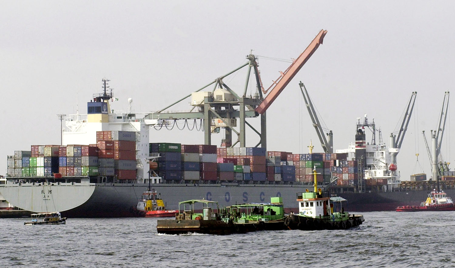 In this file photo, Pakistani vessels pass by container ships being loaded with cargo at the port of Karachi, Sept. 8, 2003. (AFP)