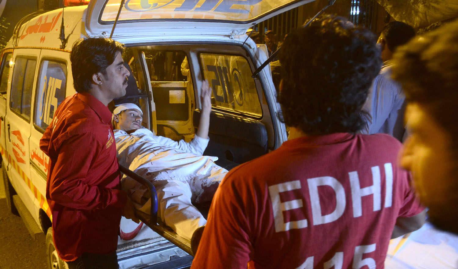 Pakistani volunteer ambulance workers transport an injured blast victim to a hospital in Karachi on Nov. 16, 2018. (AFP)