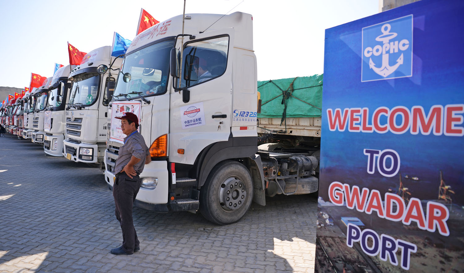 In this file photo, Chinese worker stands near trucks carrying goods during the opening of a trade project in Gwadar port, some 700 km west of the Pakistani city of Karachi on Nov. 13, 2016. (AFP)