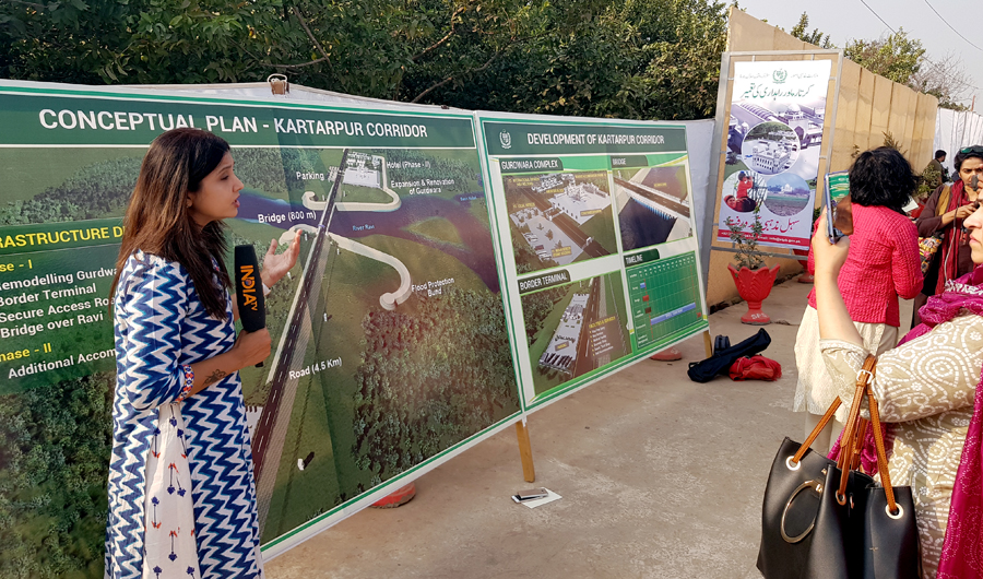 An Indian journalist reports for her news channel from the site of the proposed corridor in Kartarpur. (AN photo)