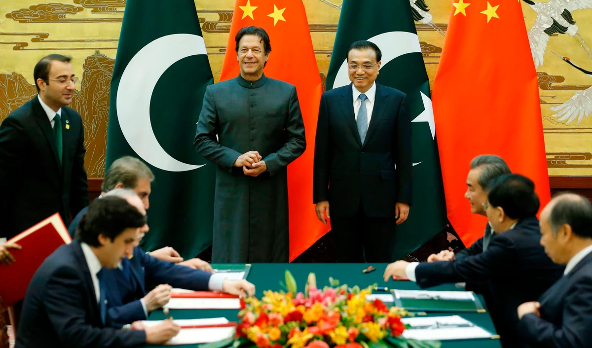 Pakistani Prime Minister Imran Khan, left, and China’s Premier Li Keqiang attend a signing ceremony at the Great Hall of the People in Beijing on November 3, 2018. (AFP)