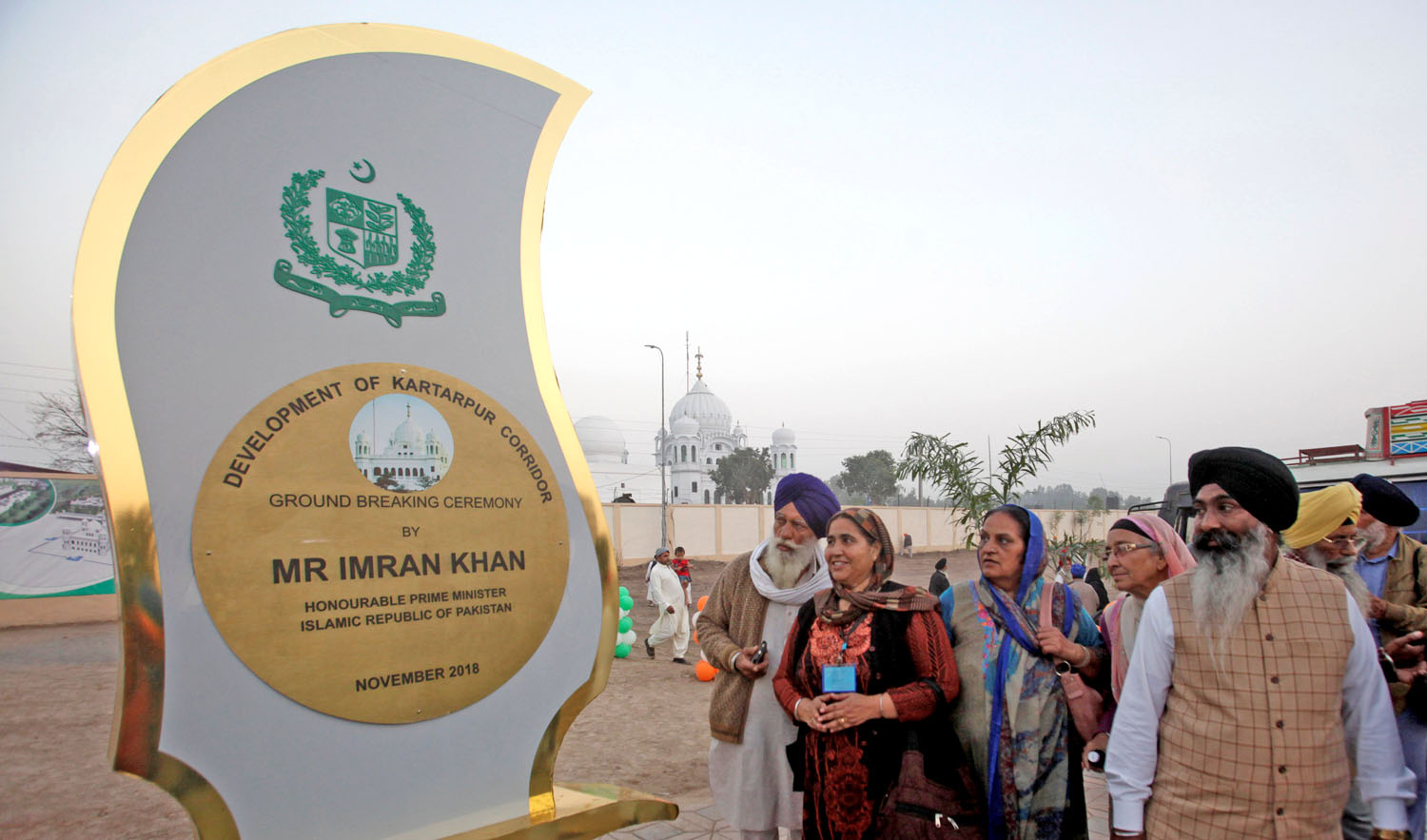 Sikhs from India look at the inaugural foundation plaque near the shrine of Sikhism’s founder, Guru Nanak, during the groundbreaking ceremony of the Kartarpur border corridor, which will officially open next year, in Kartarpur Pakistan, on Nov. 28, 2018. (REUTERS)
