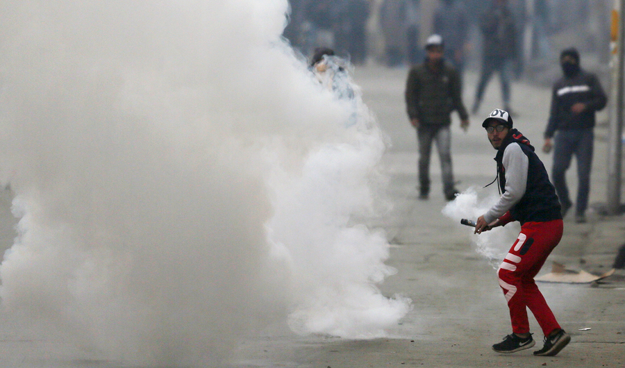 Protesters in Indian administered Kashmir clash with Indian paramilitary soldiers in Srinagar on Sunday, a day after chaotic protests and fighting killed seven civilians and four combatants in the disputed region. (AP)