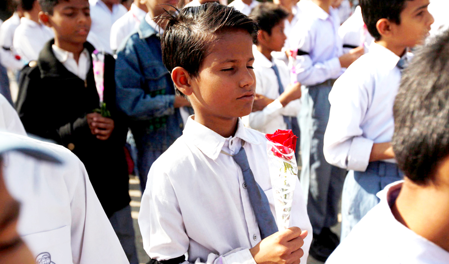 File photo for student in Karachi holding a rose takes part in a prayer for victims of the Taliban attack on Army Public School in Peshawar, on Dec. 2014. (REUTERS)