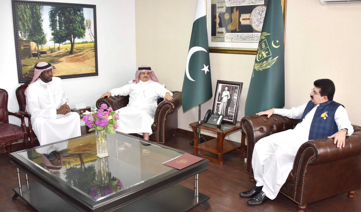 In this file photo, chairman Senate Muhammad Sadiq Sanjrani, right, exchanging views with Saudi Ambassador to Pakistan Nawaf bin Said Al-Malki, center, at the Parliament House in Islamabad on Aug. 10, 2018. (APP)