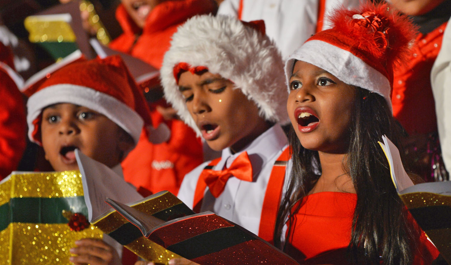 Children wearing Santa Claus costumes sing in a choir during a Christmas service at Saint Patrick’s Cathedral in Karachi on Dec. 22, 2018. (AFP/File)