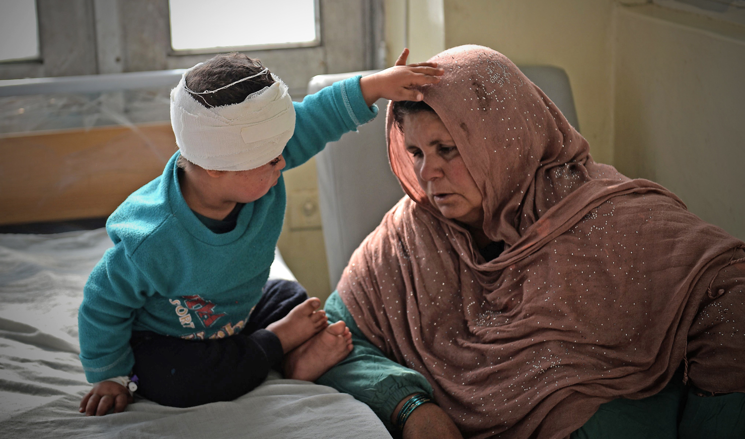 An Afghan woman sits next to a wounded child after receiving treatment at Indira Gandhi Children’s Hospital after a powerful truck bomb attack in Kabul on Jan. 15, 2019. (AFP)