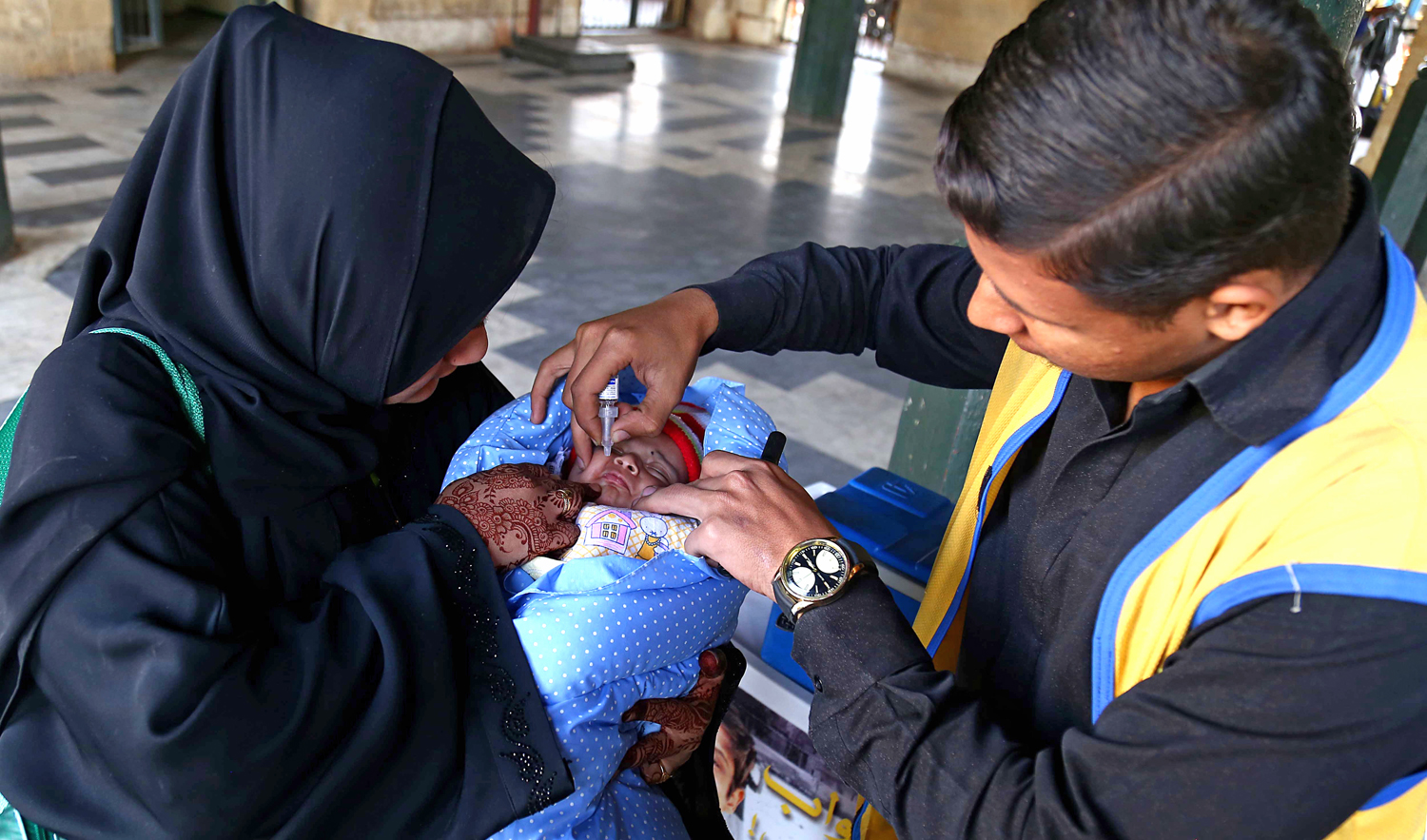 In this file photo, a health worker administers polio vaccination on children, in Karachi, Pakistan, January 14, 2019. (AFP)