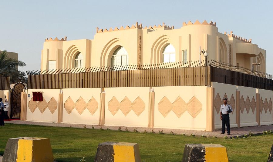 Security guards stand outside the new Taliban political office in Doha. (File/AFP)