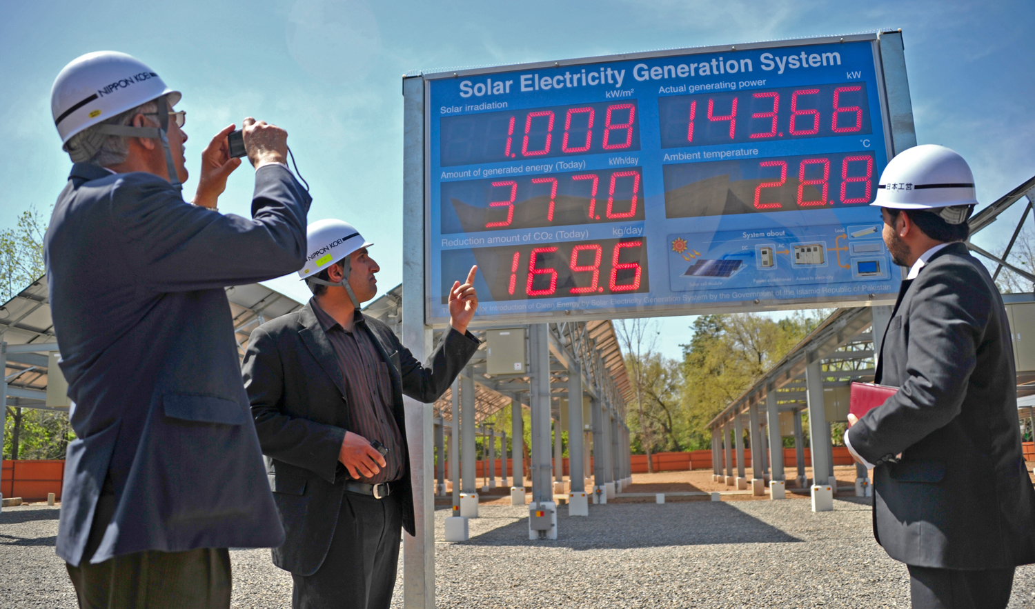 In this file photo, engineer and consultants monitor a solar electricity generator system display showing the reduction in the amount of carbon dioxide (below left) from being released, through the use of renewable energy, in Islamabad on March 29, 2012. (AFP)