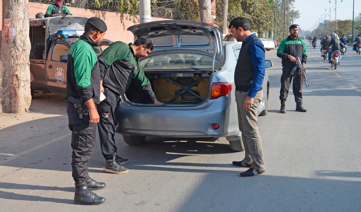 Pakistani police officers check a vehicle as security is beefed up in the eastern city of Faisalabad, Pakistan, Tuesday, Jan. 15, 2019. (AFP)