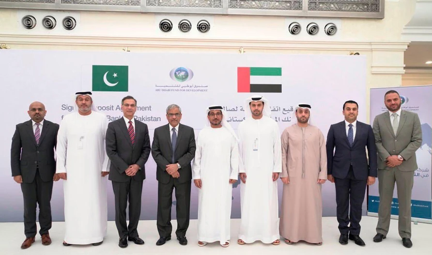 Mohammed Saif Al Suwaidi, director general of Abu Dhabi Fund for Development, and Tariq Bajwa, governor of the State Bank of Pakistan, can be seen along with officials of the two countries on Tuesday after signing an agreement in Abu Dhabi. (Photo Courtesy: UAE Embassy in Pakistan)