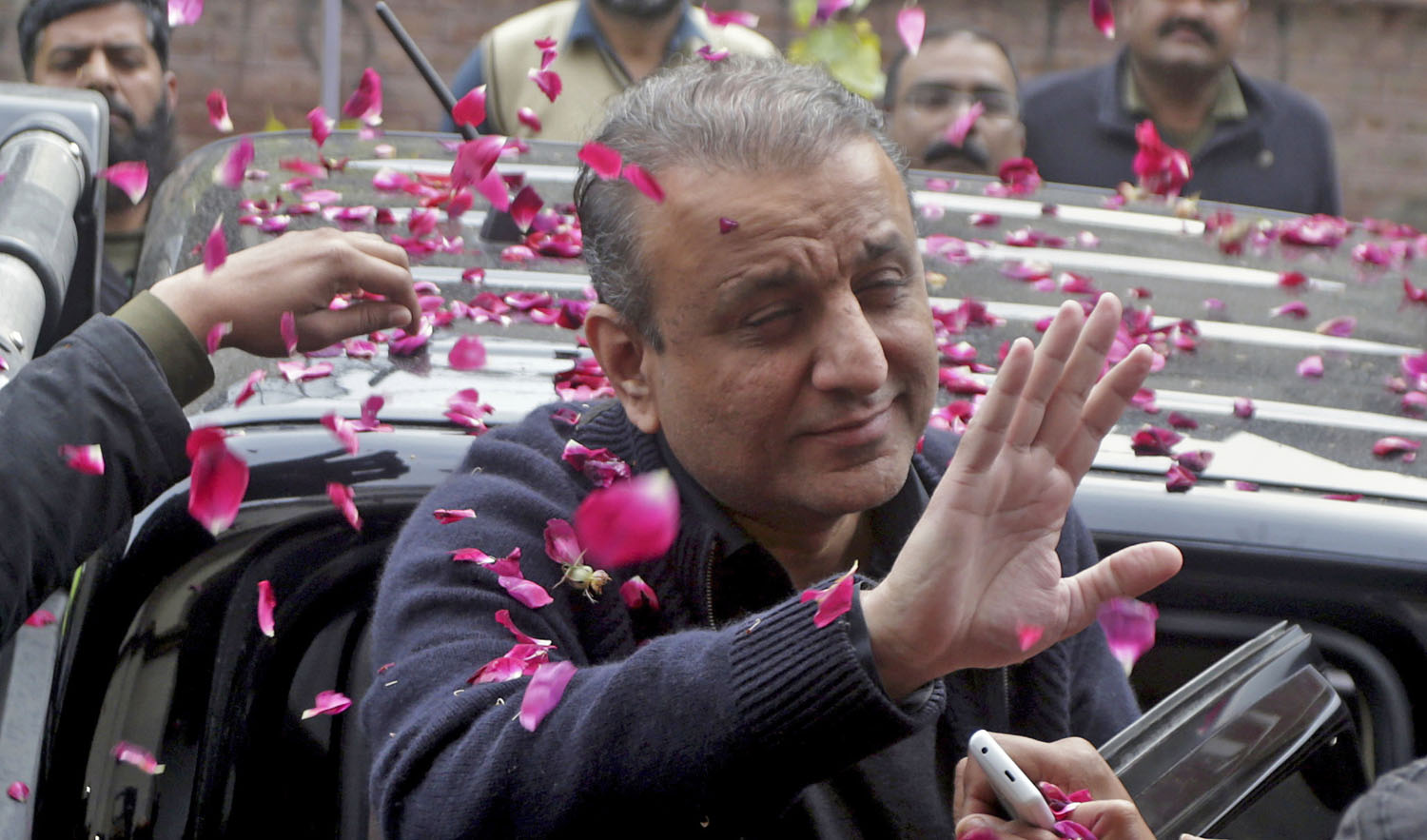 People shower rose petals on former Punjab Provincial Minister for Local Bodies, Abdul Aleem Khan arrives at the anti-graft tribunal in Lahore, Pakistan, Thursday, Feb. 7, 2019. (AP)