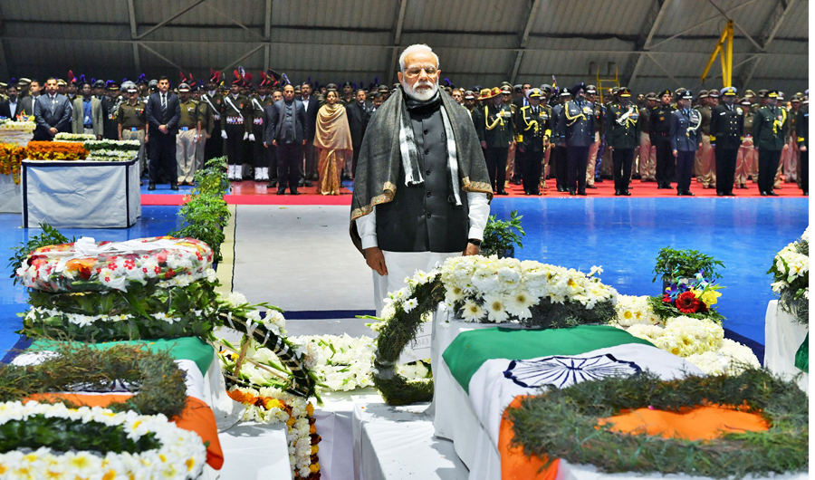 India's Prime Minister Narendra Modi pays tribute at Palam airport in New Delhi on February 15, 2019 as he stands next to the coffins containing the remains of Indian paramilitary troopers who were killed after a suicide bomber rammed a car into a bus carrying them in south Kashmir the day before. (India's Press Information Bureau/Handout via REUTERS)
