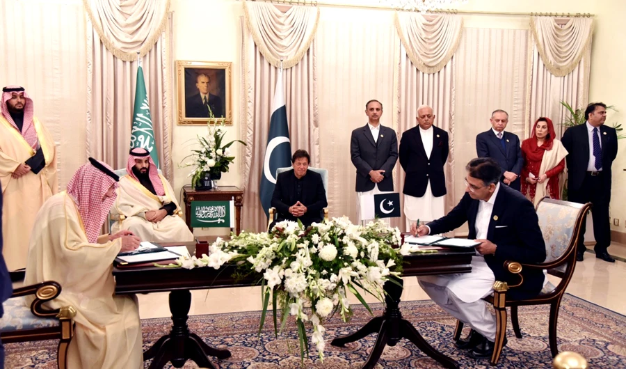 Prime Minister Imran Khan and Saudi Crown Prince Mohammed bin Salman watch officials of the two countries sign seven memoranda of understanding worth $20 billion in Islamabad on Sunday. (PM Office)
