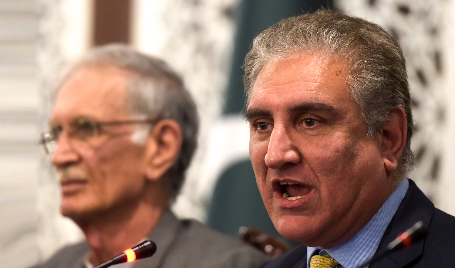 In this file photo, Pakistani Foreign Minister Shah Mehmood Qureshi, right, speaks next to the media at the Foreign Affairs Ministry in Islamabad on Feb. 26, 2019. (AFP)