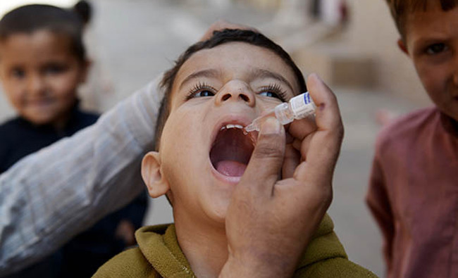 A polio worker administers anti-polio drops to a child in the newly-merged tribal district. The campaign starts at the Torkham border from March 25. Photo courtesy Emergency Operation Center (EOC) Khyber Pakhtunkhwa (KP). (AFP/File)