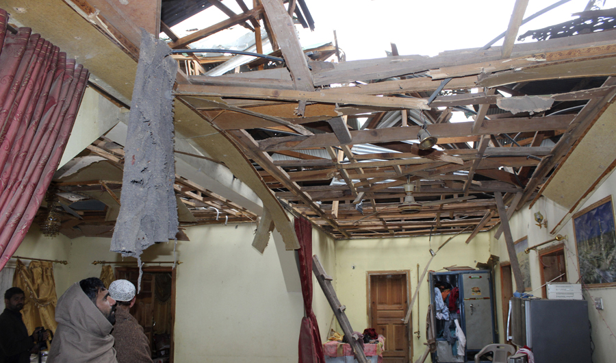 Pakistani Kashmiris look at a house that was damaged by Indian artillery shelling near the Line of Control between Pakistani and Indian-controlled Kashmir, in Mara Bakot, near Muzafarabad, the capital of Pakistani Kashmir, on March 11, 2019. (AP)