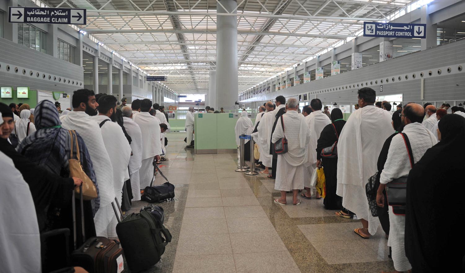 In this file photo, Pakistani Muslims wait to pass security as the first pilgrims for the annual Hajj pilgrimage arrive in Jeddah on July 24, 2017. (AFP)