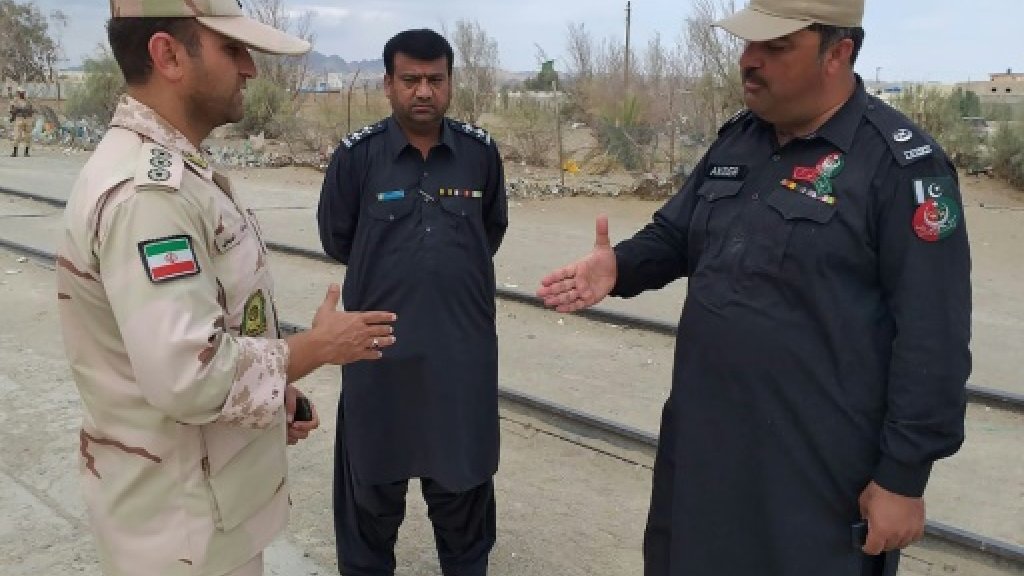 Iranian (L) and Pakistani security officials meet at Zero Point in the border town of Taftan on October 16, 2018, the day jihadists seized 12 Iranian security personnel near the border. (AFP)