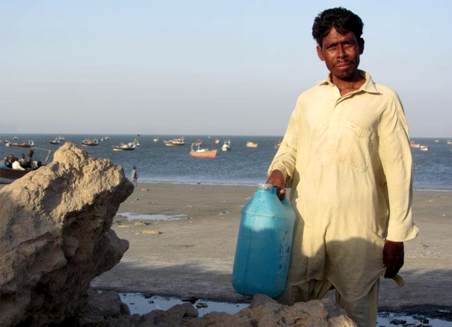 A fisherman holds a jerry can of drinking water near Pakistan's Arabian Sea port of Gwadar, on April 1, 2018. (Reuters/File)