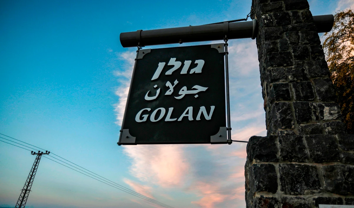 This file photo shows a sign reading Golan in Hebrew, Arabic, and English, located at the 1967 Israel-Syria border point, near the sea of Galilee in the Israeli-annexed Golan Heights on March 24, 2019. (AFP/File)